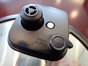 Pressure cooker lid pressure-release valve